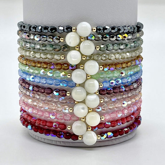 Wedding jewelry for bridesmaids. Crystal bracelets in a wide range of colors with mother-of-pearl and gold accent beads. Handmade custom bracelets.