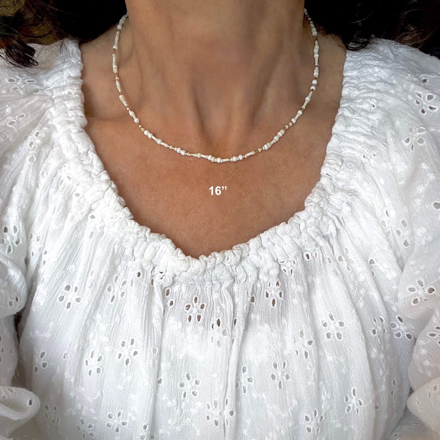 White and ivory 16" seed bead choker stretch necklace with gold-tone accents.