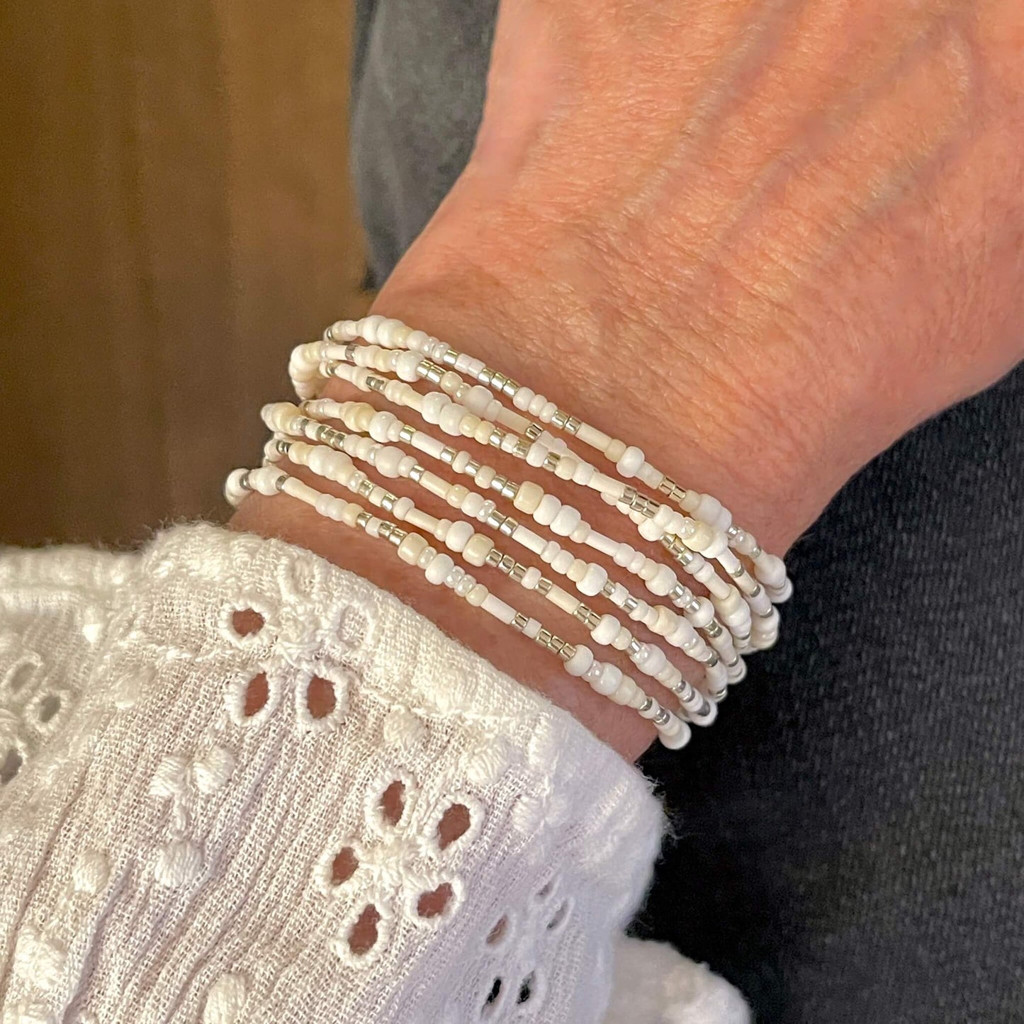 White, ivory, and silver-tone beaded wrap stretch bracelet, necklace, or anklet with seed beads.