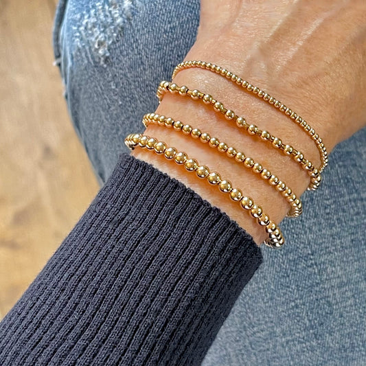 Women's Rose Gold Hand Beaded Bracelets with 14K gold-filled beads in 2mm, 3mm, and 4mm sizes on stretch cord.