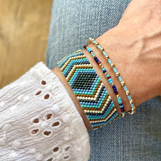 Flat beaded bracelet in navy, turquoise and brown diamond and chevron peyote pattern, with 2 gold filled and glass bead stretch bracelets.