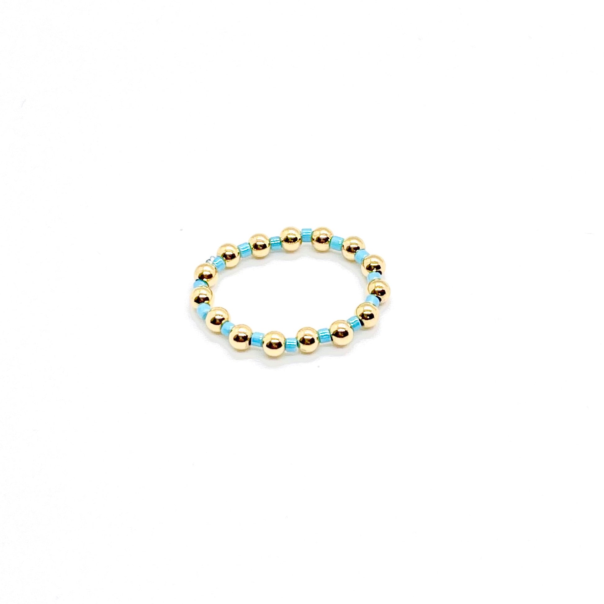 Beaded ring | 3mm gold ball ring with alternating blue seed beads on stretch cord.