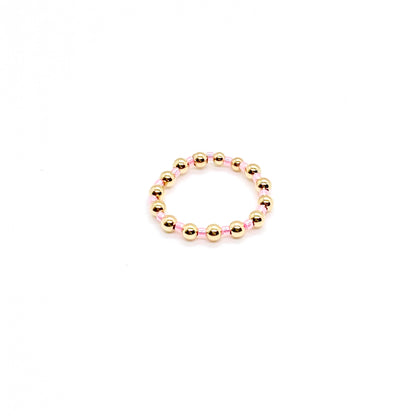 Beaded ring | 3mm gold ball ring with alternating pink seed beads on stretch cord.
