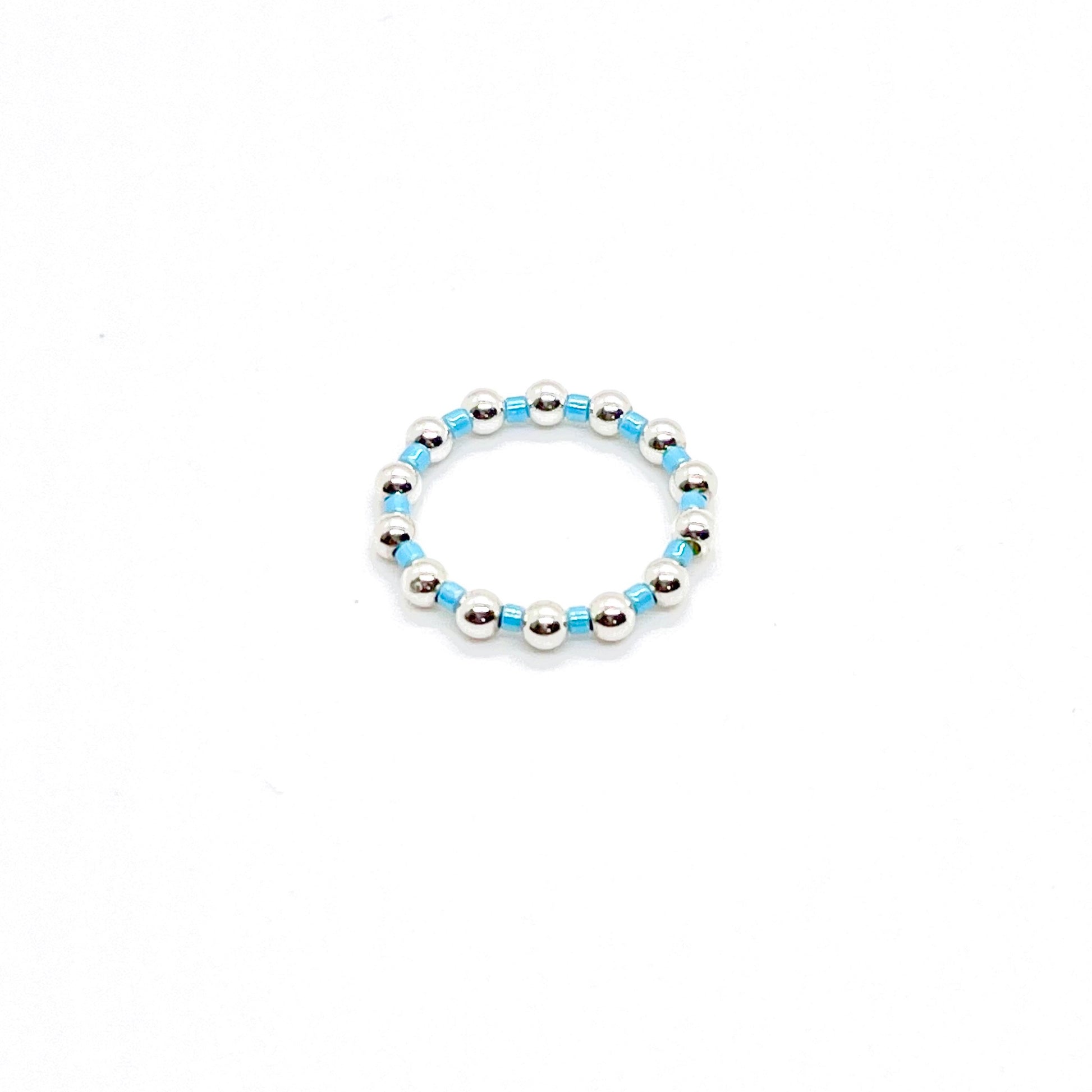Beaded ring | 3mm sterling silver ball ring with alternating blue seed beads on stretch cord.