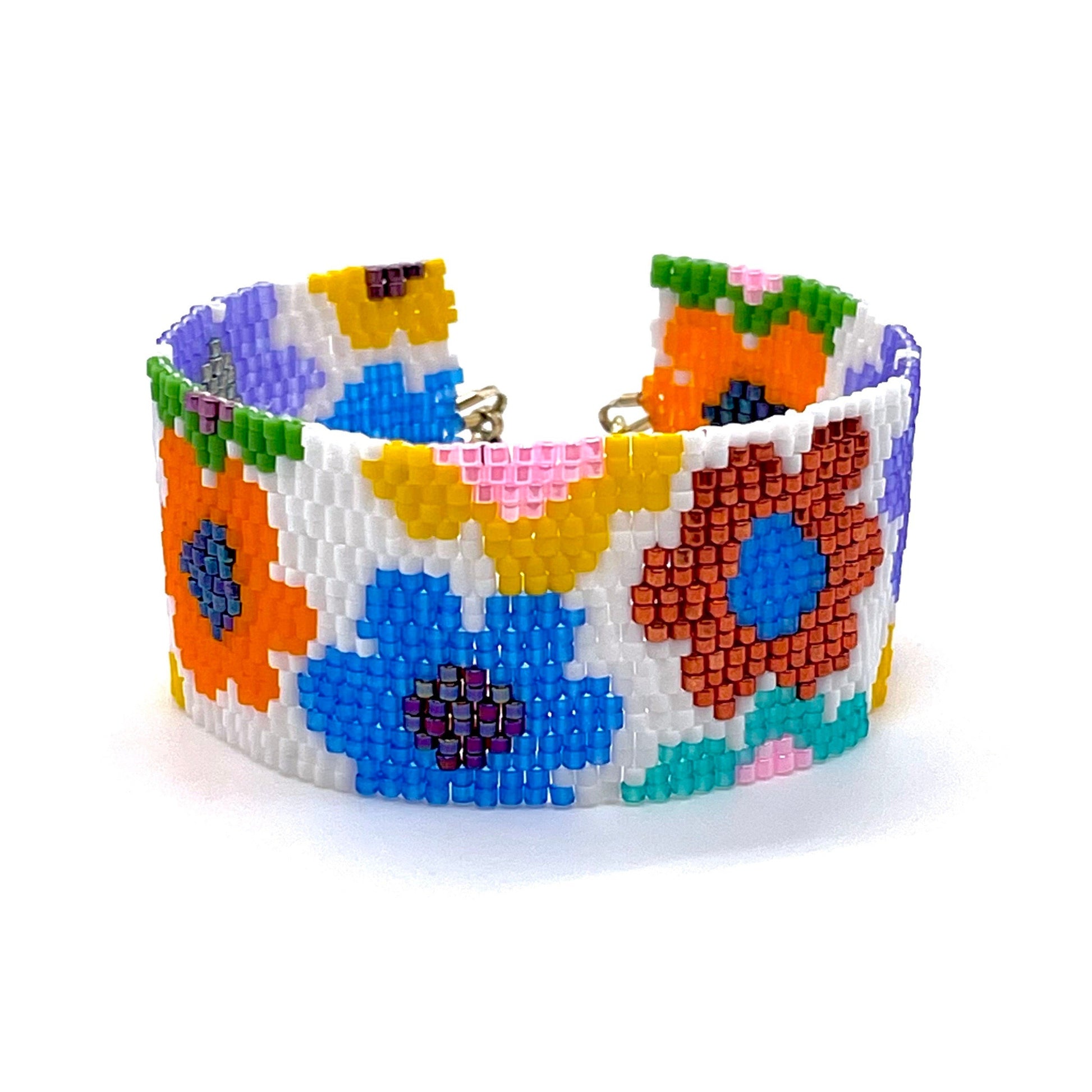 Trendy women's daisy beaded statement seed bead bracelet band with large flowers in pops of bright colors on a white background.