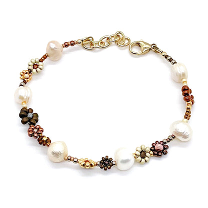 Daisy chain bracelet with freshwater pearls and brown, tan, and gold seed beads.