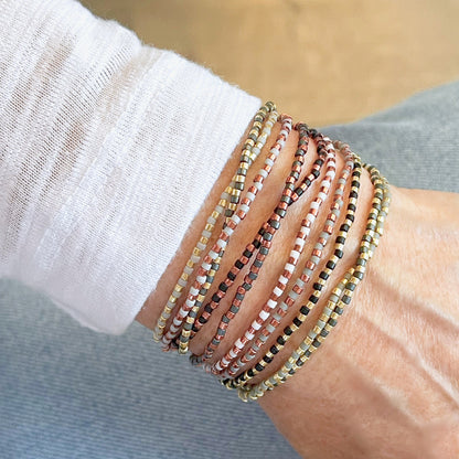 Wrap beaded bracelets with gold, copper, grey and black seed beads.