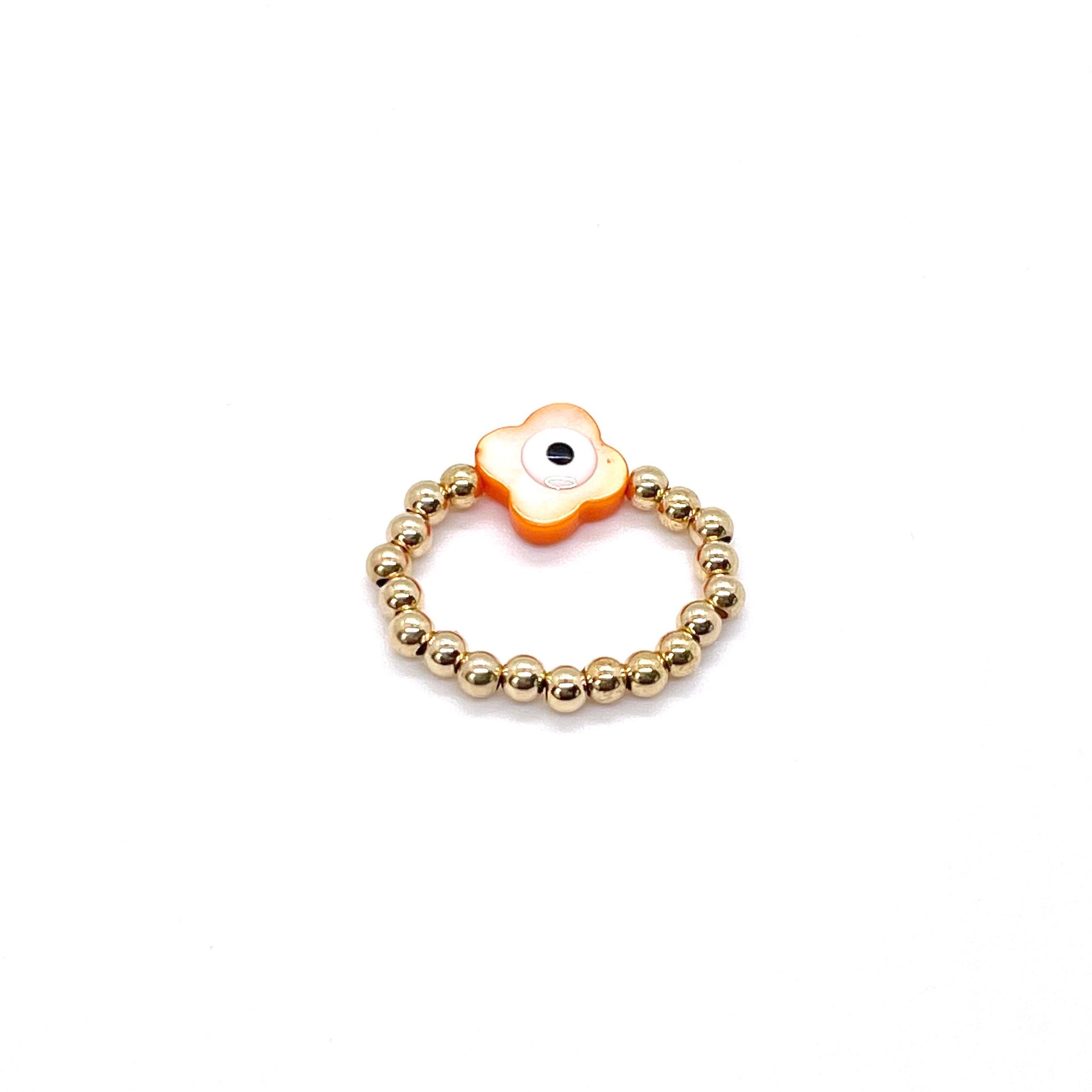Evil eye gold ring with orange shell evil eye on 3mm gold ball stretch band.