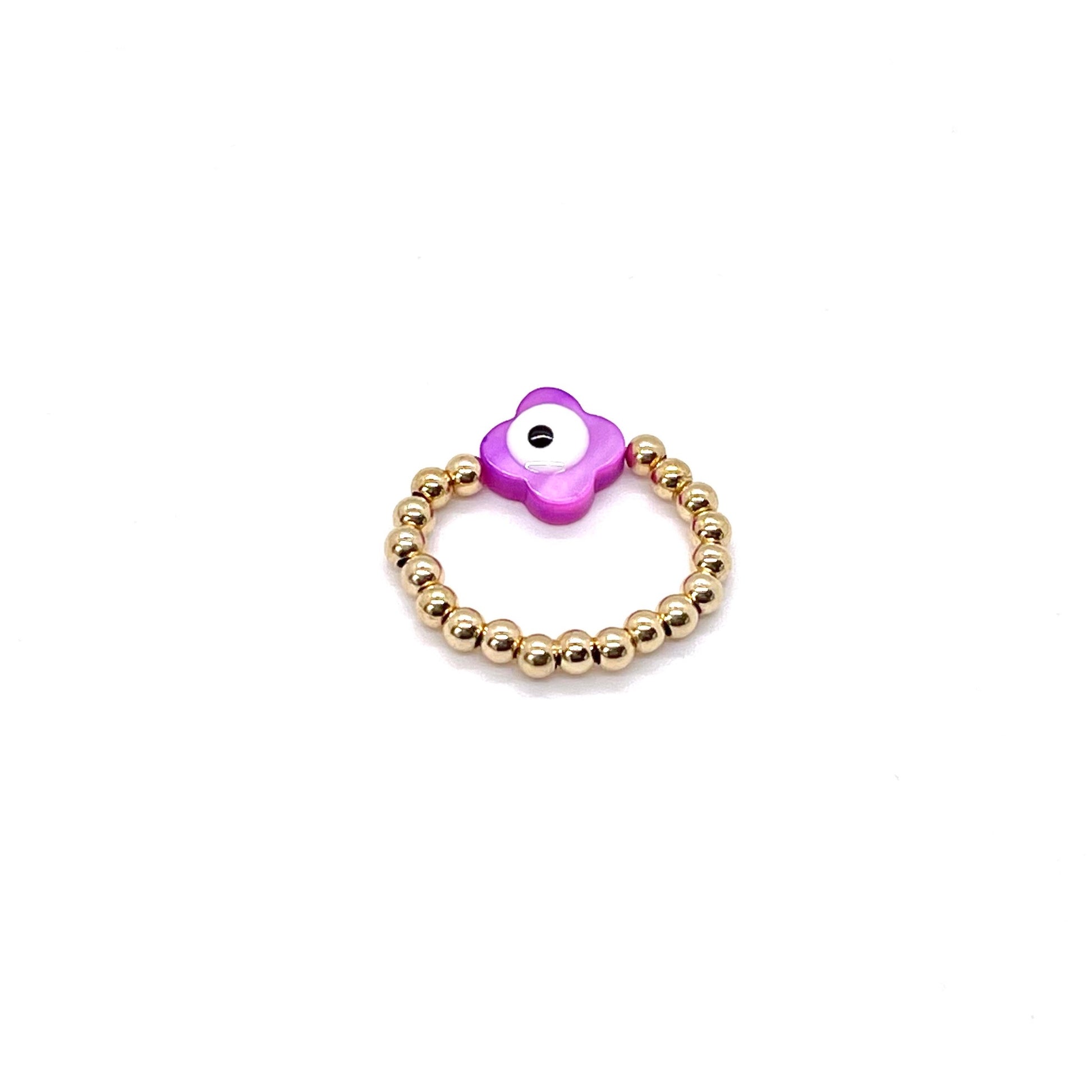 Purple shell evil eye ring with 3mm gold ball strech band.
