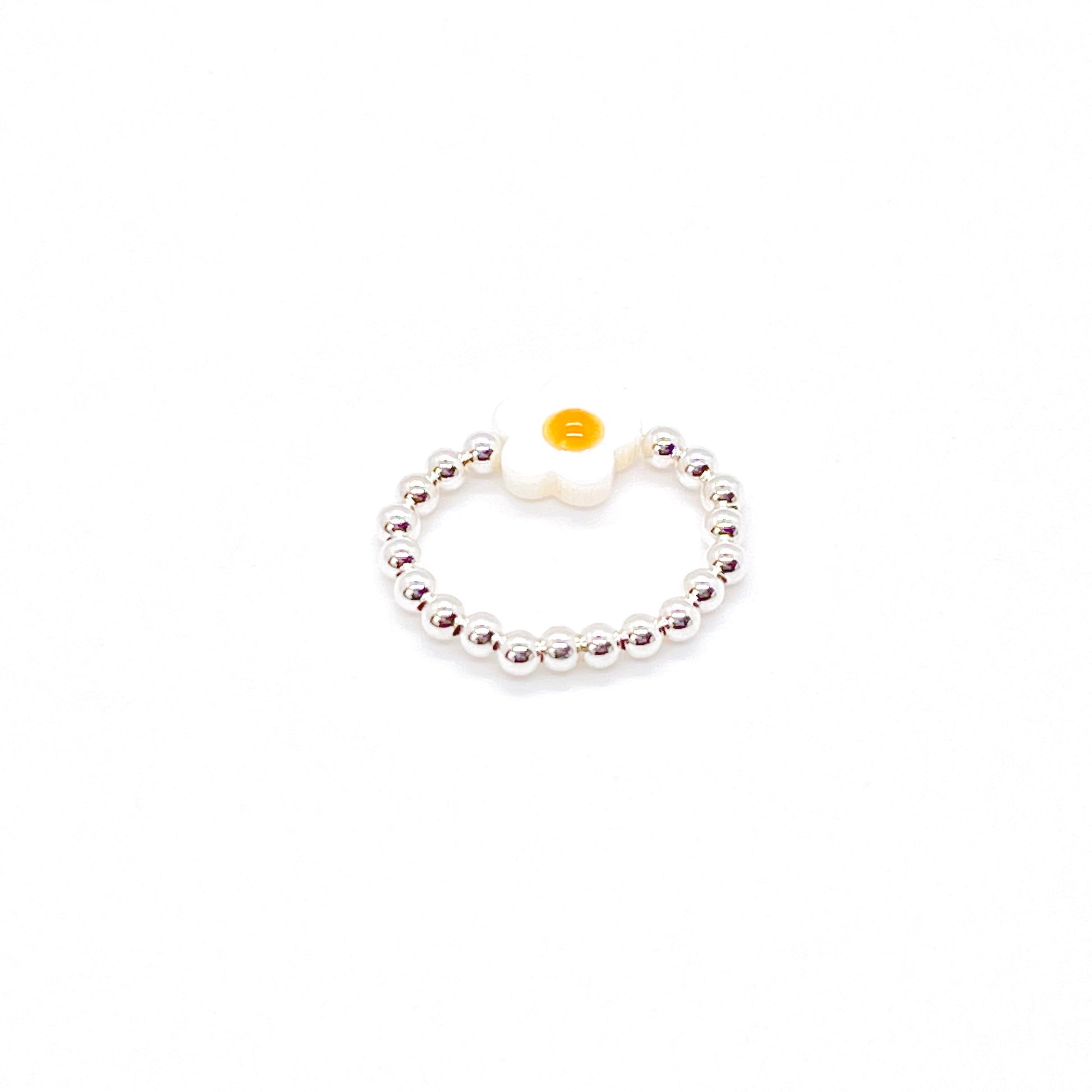 Flower bead ring with a sterling silver 3mm ball bead stretch band and a white and yellow shell flower bead.