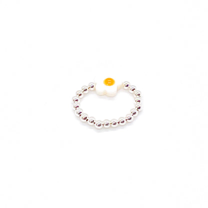 Flower bead ring with a sterling silver 3mm ball bead stretch band and a white and yellow shell flower bead.