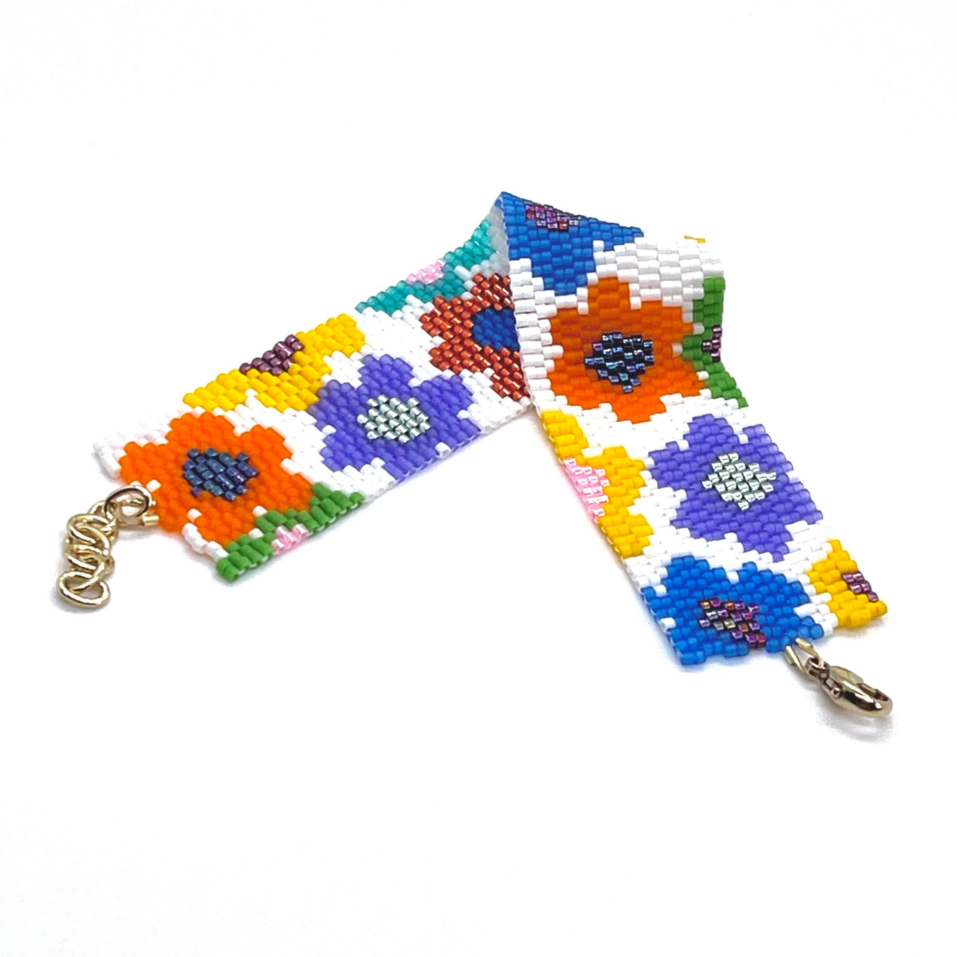 Flower bead bracelet band with white background and large bright multi color seed bead daisies.
