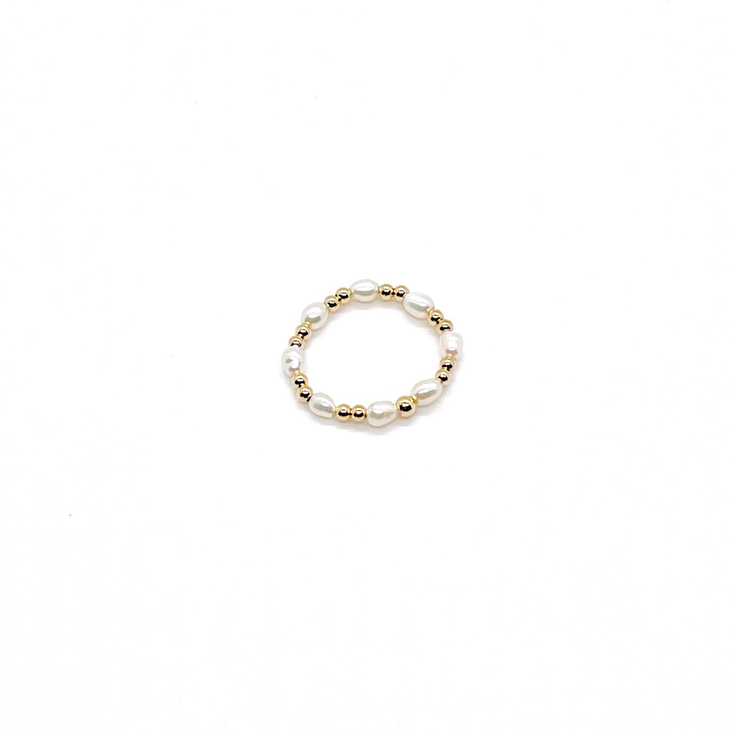 Freshwater pearl ring with rice pearls and alternating 2mm 14K gold filled beads on a stretch cord.