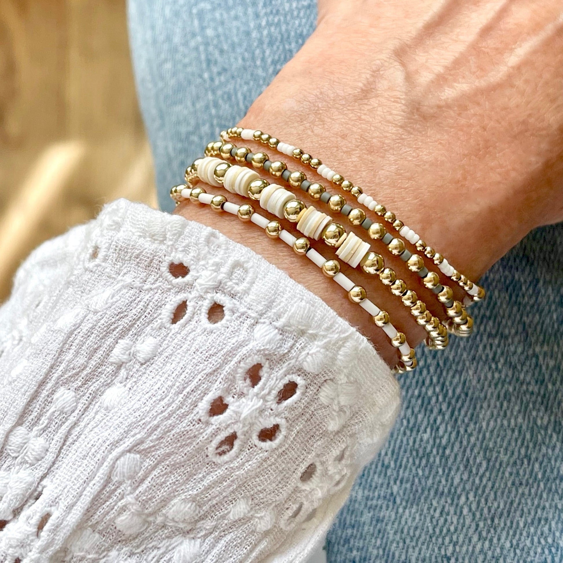 Heishi bracelet and gold bead stretch bracelets with white and gray glass seed beads and 14k gold fill beads.