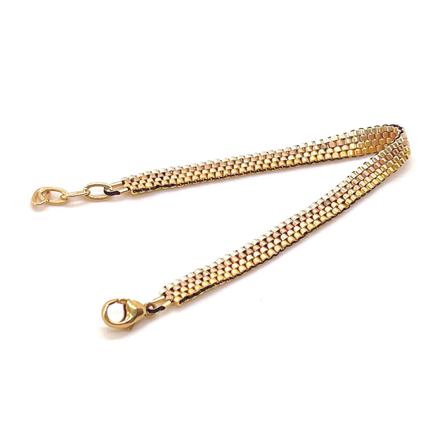 Horizontal stripes gold tone metal bead woven bracelet with seed beads and a gold filled clasp.