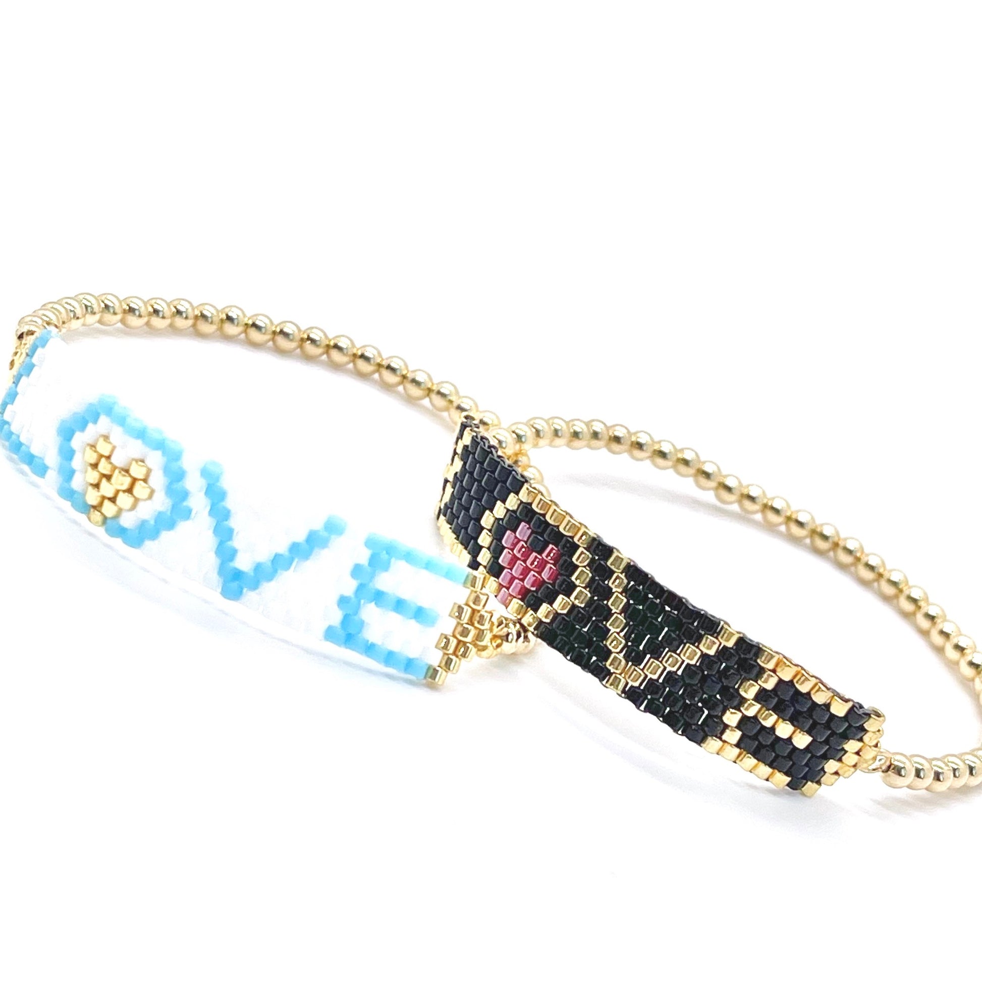 Stacking love bracelets with white, black, blue, and gold beads. Gold stretch bracelets.