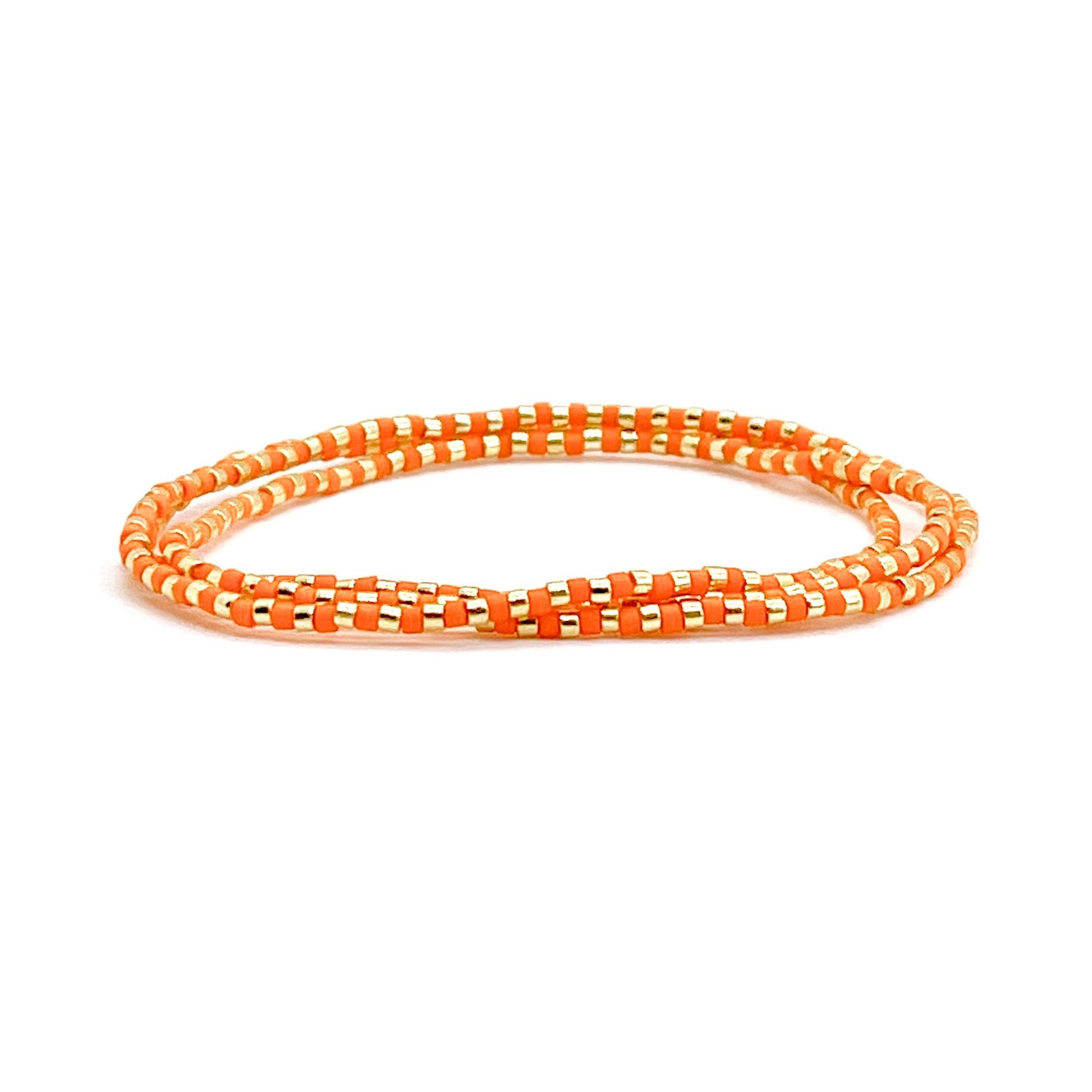 Wrap bracelet with small orange and gold-tone glass seed beads on stretch cord.
