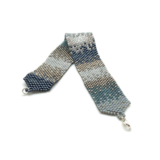 Flat ombre beaded wide bracelet cuff in muted tones of slate blue, gray and silver with a modern, boho style.