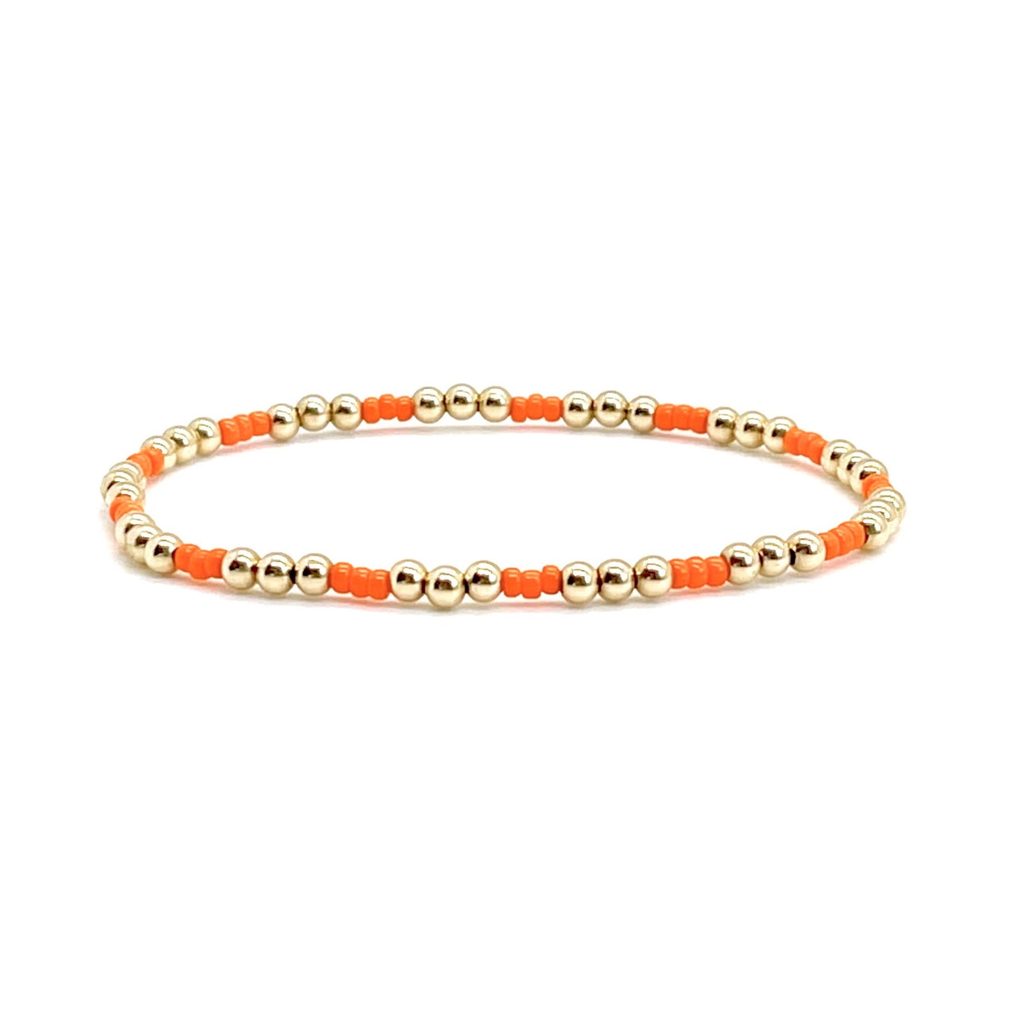 Orange seed bead bracelet with 3mm round gold filled beads on stretch cord.