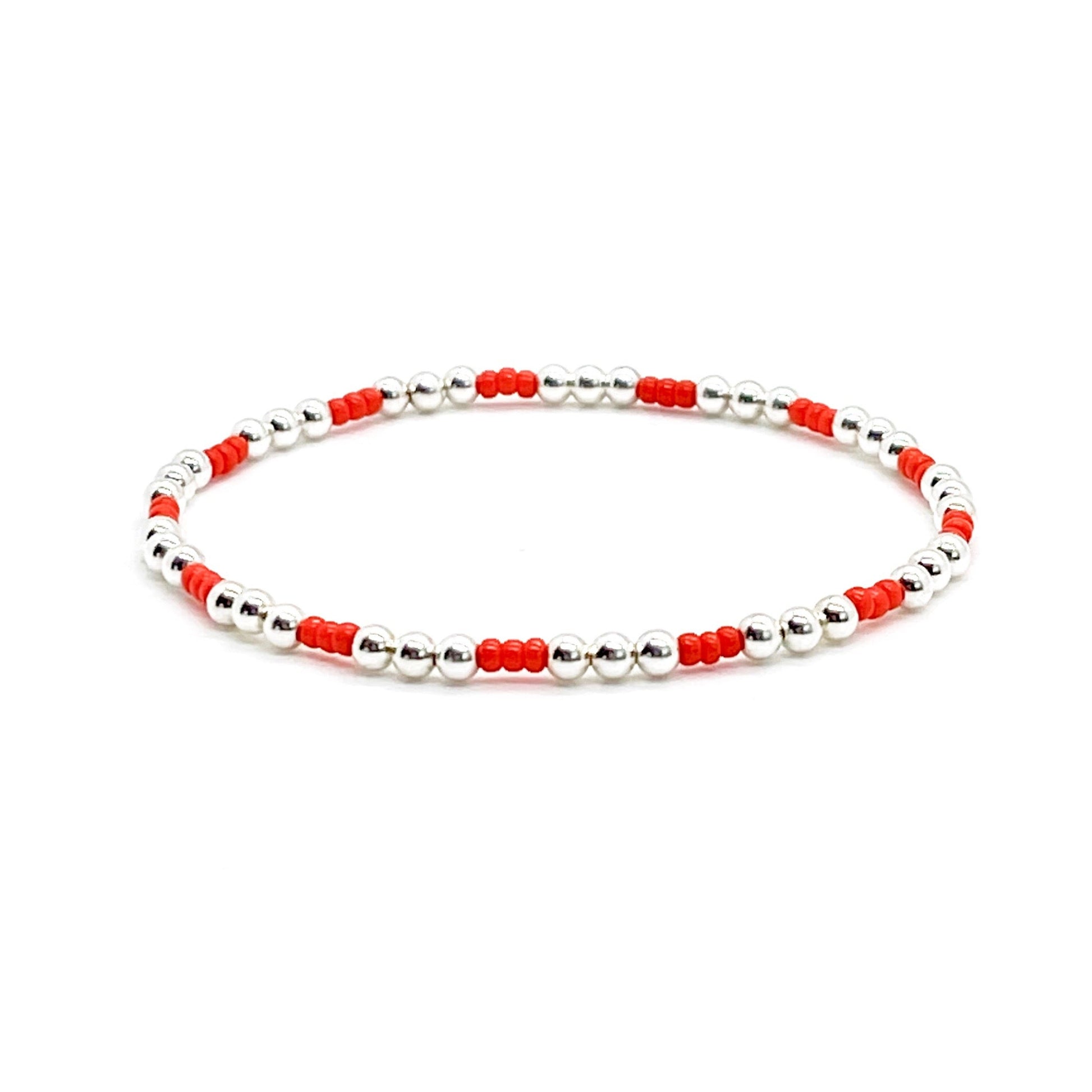 Red bead bracelet with sterling silver 3mm round beads on stretch cord.