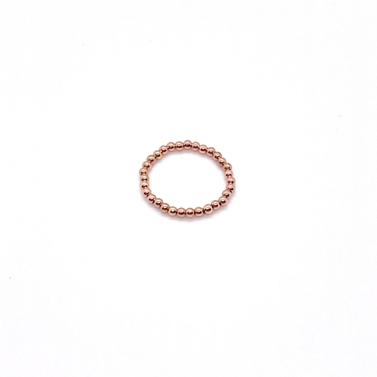 Rose gold bead ring with 2mm 14K gold filled waterproof beads on elastic stretch cord.
