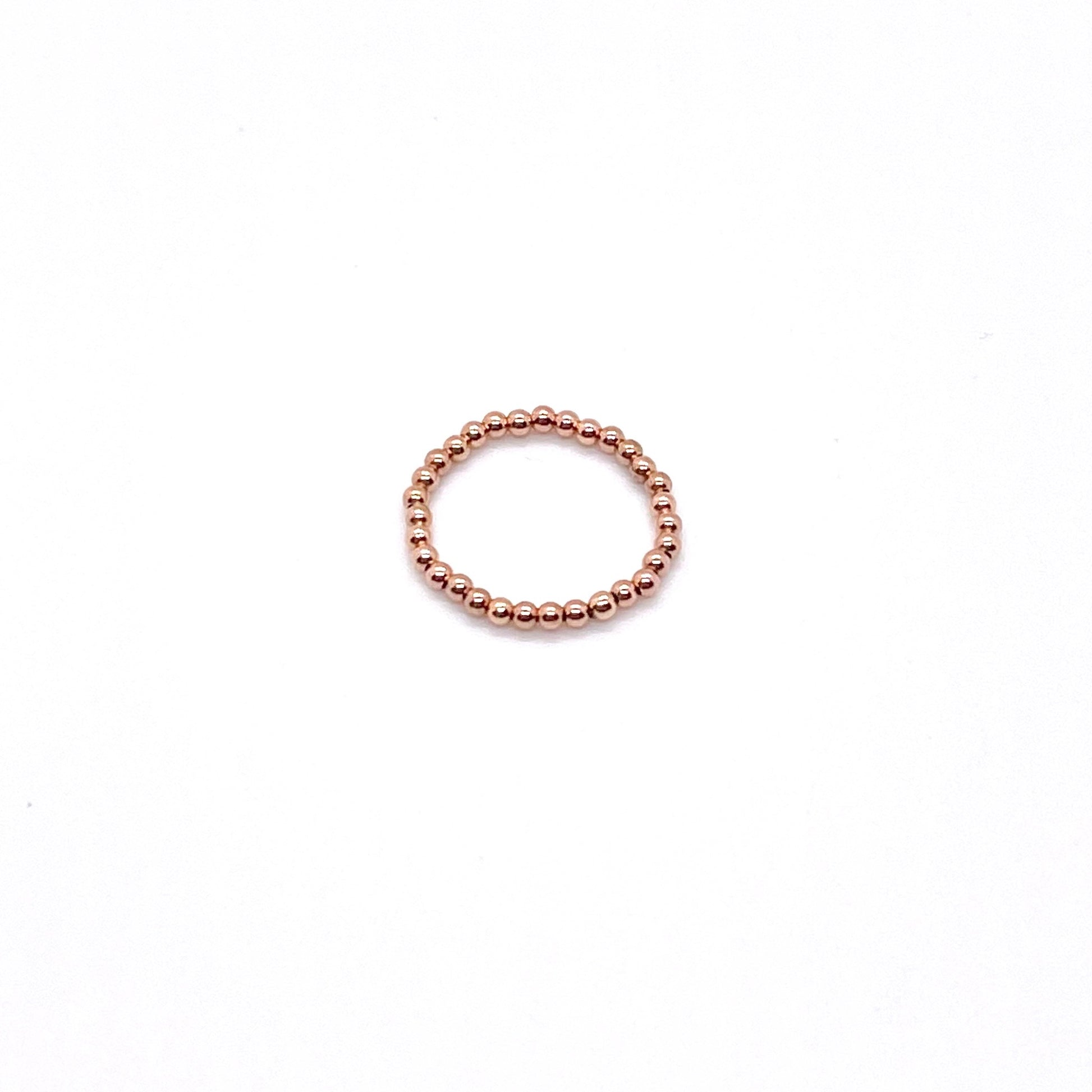 Rose gold bead ring with 2mm 14K gold filled waterproof beads on elastic stretch cord.