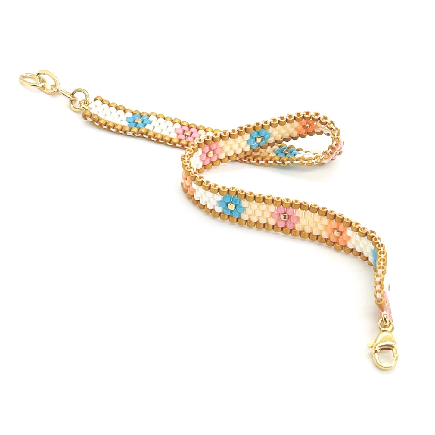 Seed bead flower bracelet with pink, blue, white , and gold beads. Flat beaded bracelet. Handmade in NYC.