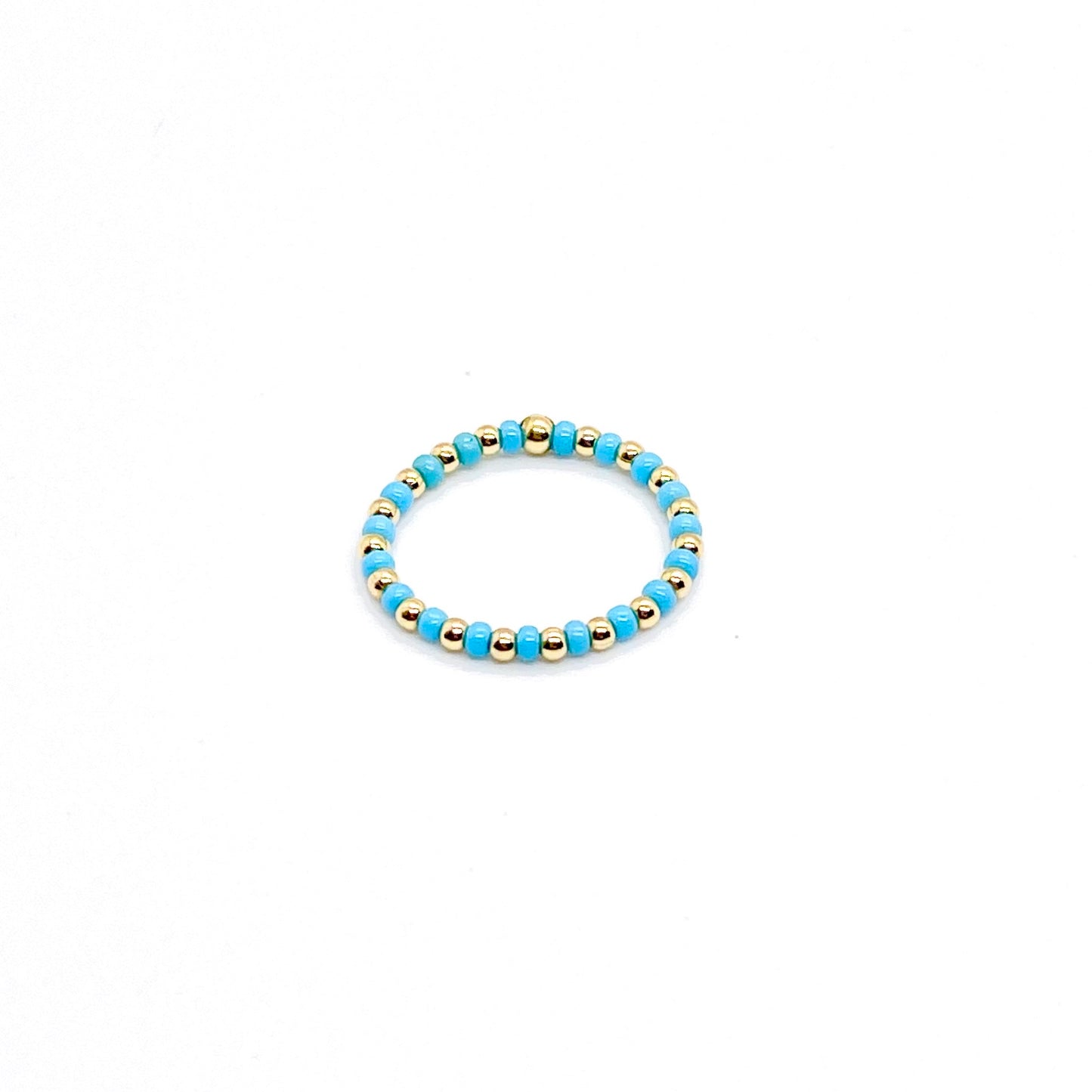 Seed bead ring | 2mm gold ball ring with alternating blue seed beads on stretch cord.