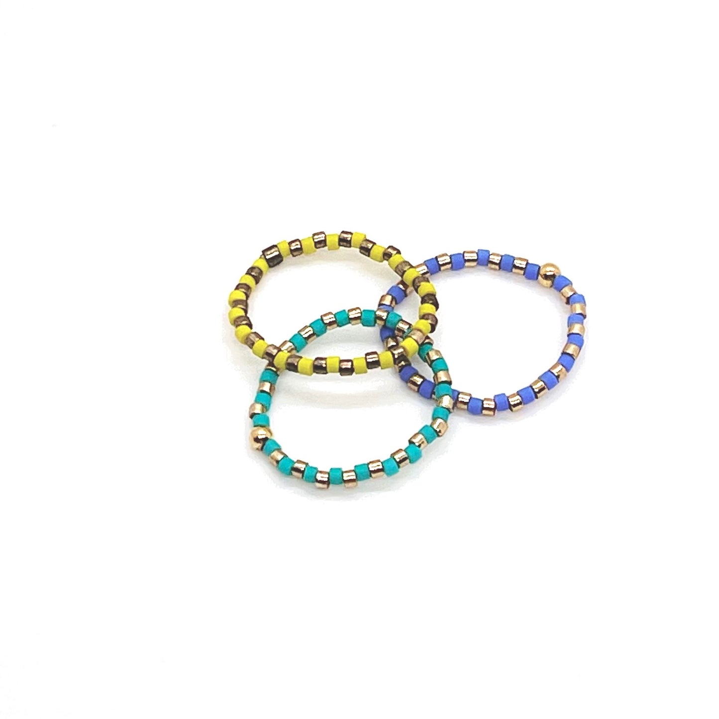 Beaded stretch ring set of 3 with alternating  metal-tone, and aqua, yellow, and periwinkle Miyuki Delica seed beads.