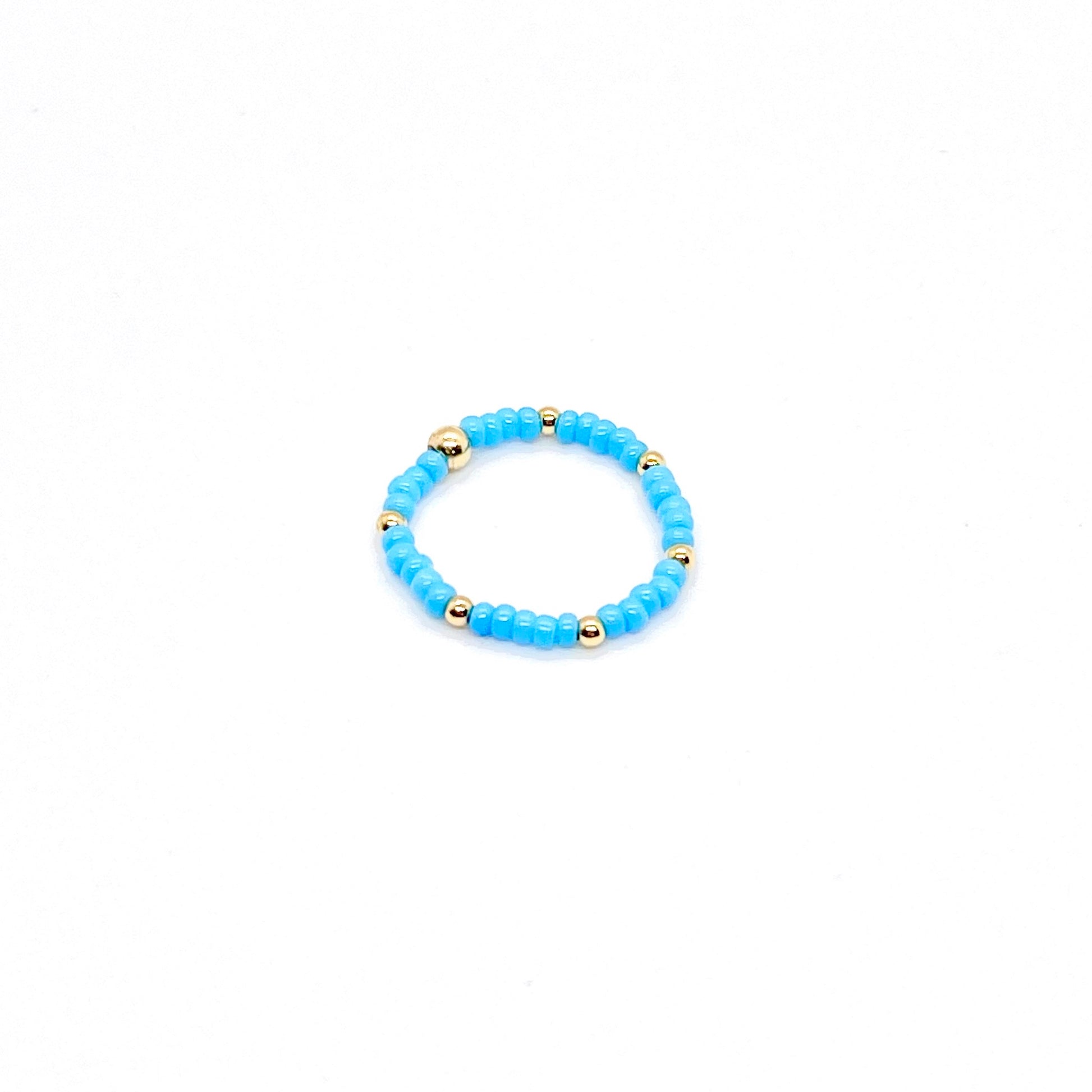 Stretch ring with blue seed beads and 14K gold filled ball accent beads.
