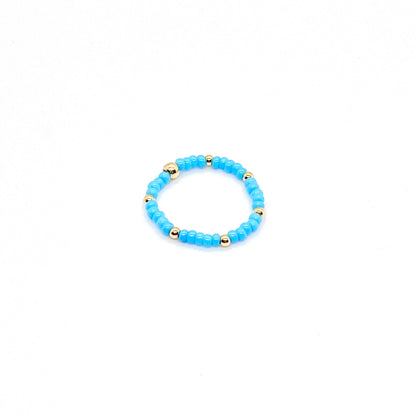 Stretch ring with blue seed beads and 14K gold filled ball accent beads.