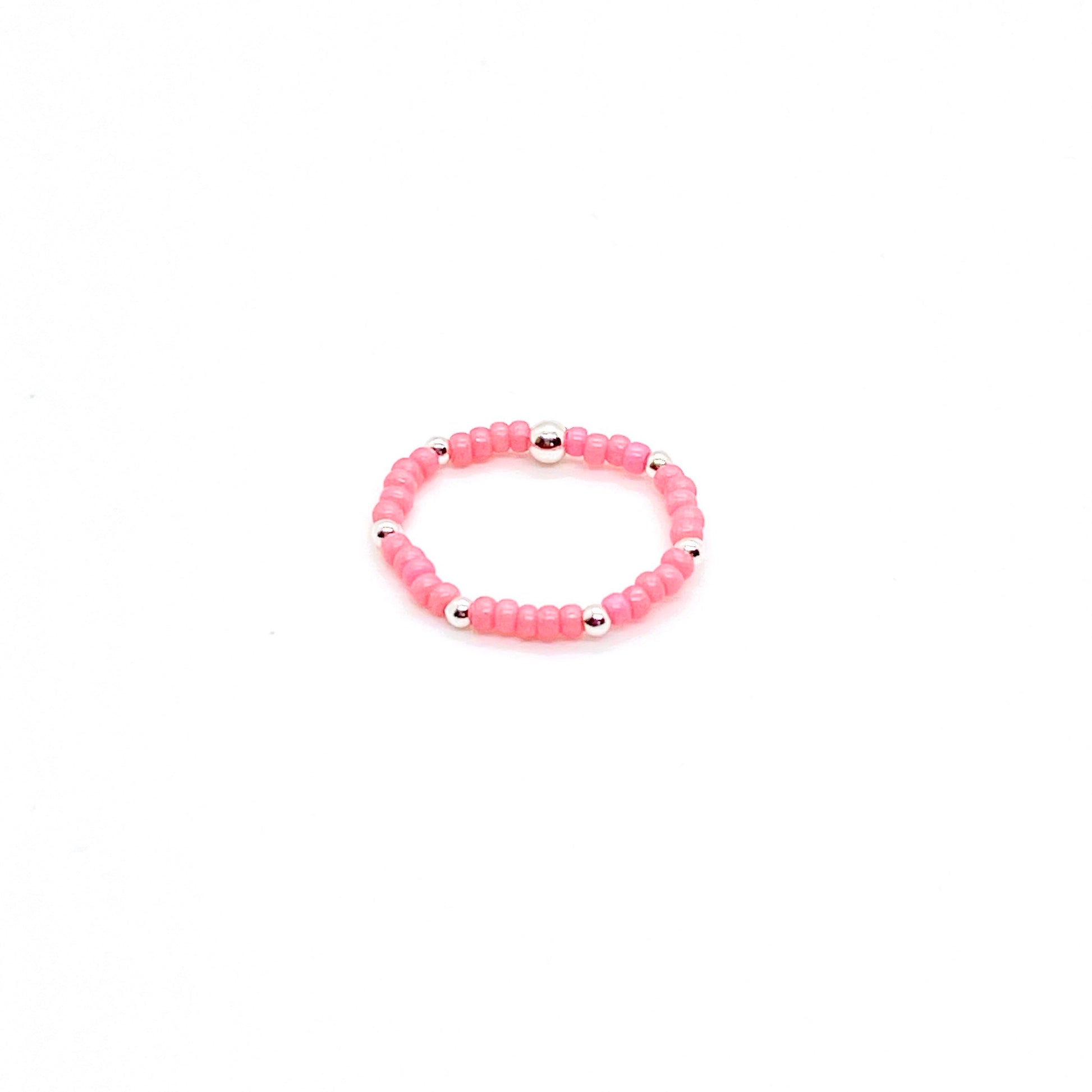 Stretch rink with pink seed beads and 2mm sterling silver waterproof accent ball beads.