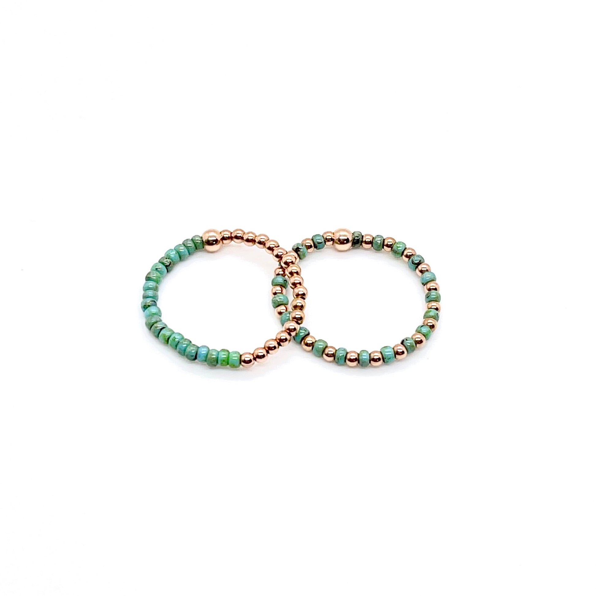 Stretch ring set with turquoise color block and seed beads alternating with 2mm 14K rose gold filled balls on stretch cord.