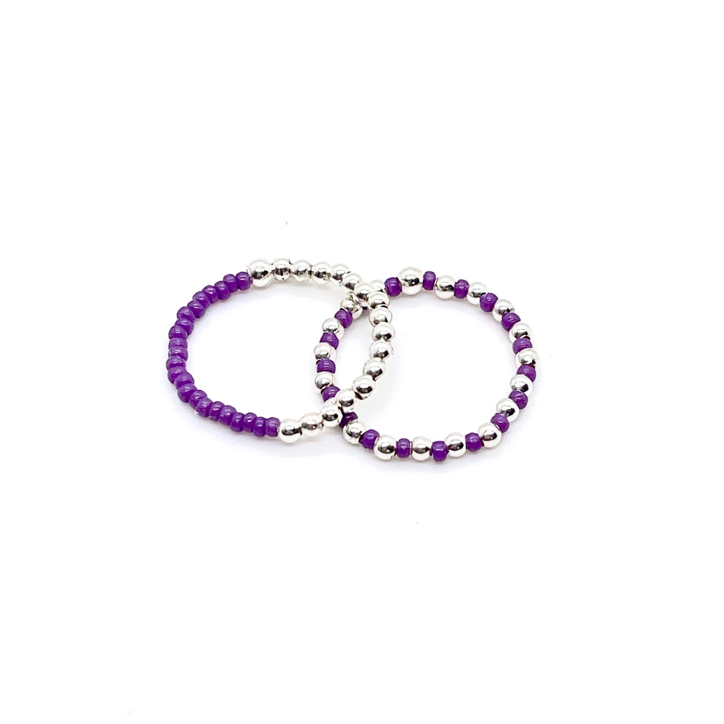 Stretch ring set with purple color block and seed beads alternating with 2mm sterling silver balls on stretch cord.