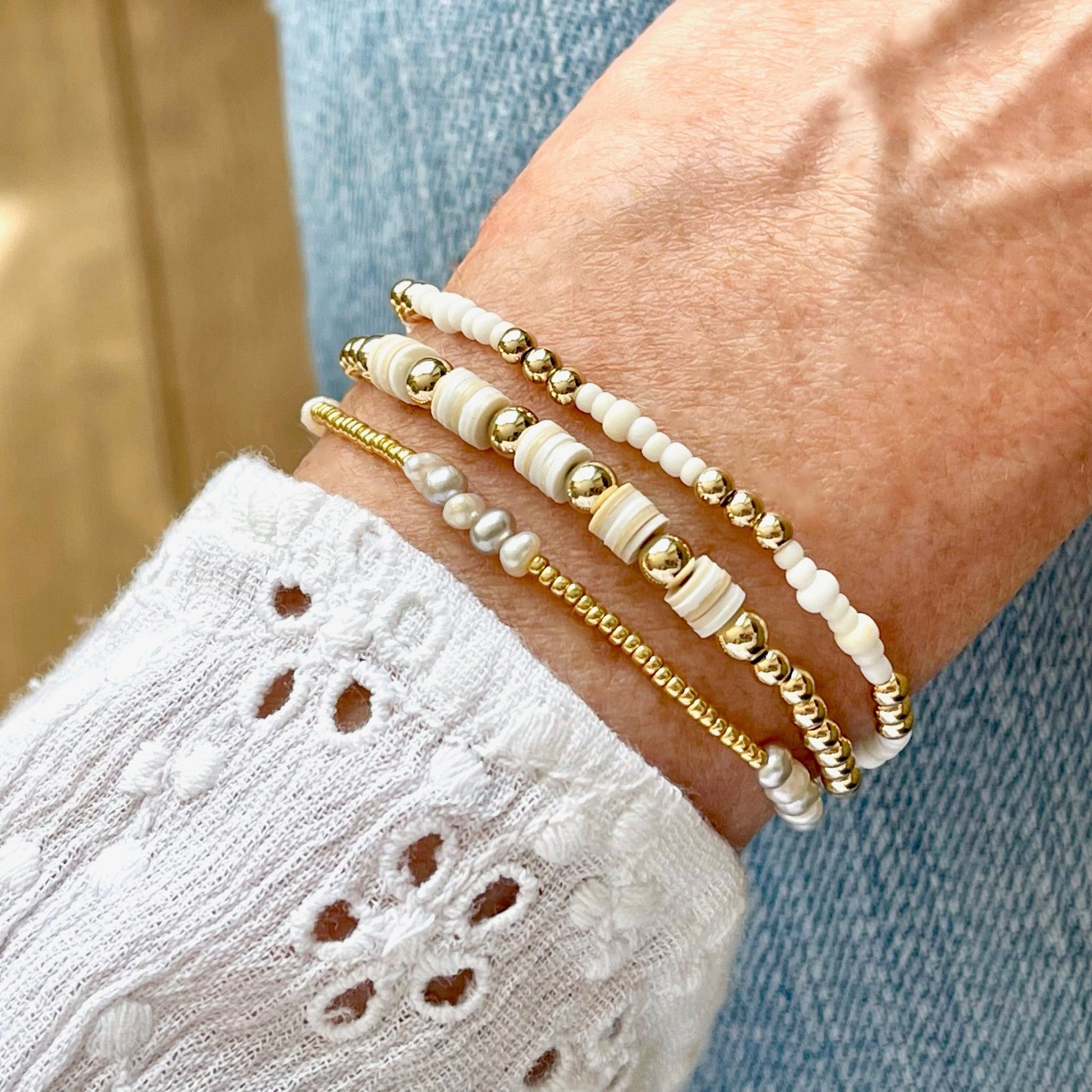 Heishi bead bracelet, freshwater pearl bracelet, and white beaded bracelet with gold beads. Set of 3 stretch bracelets.