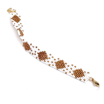 White beaded bracelet with bronze seed bead handwoven diamond pattern.