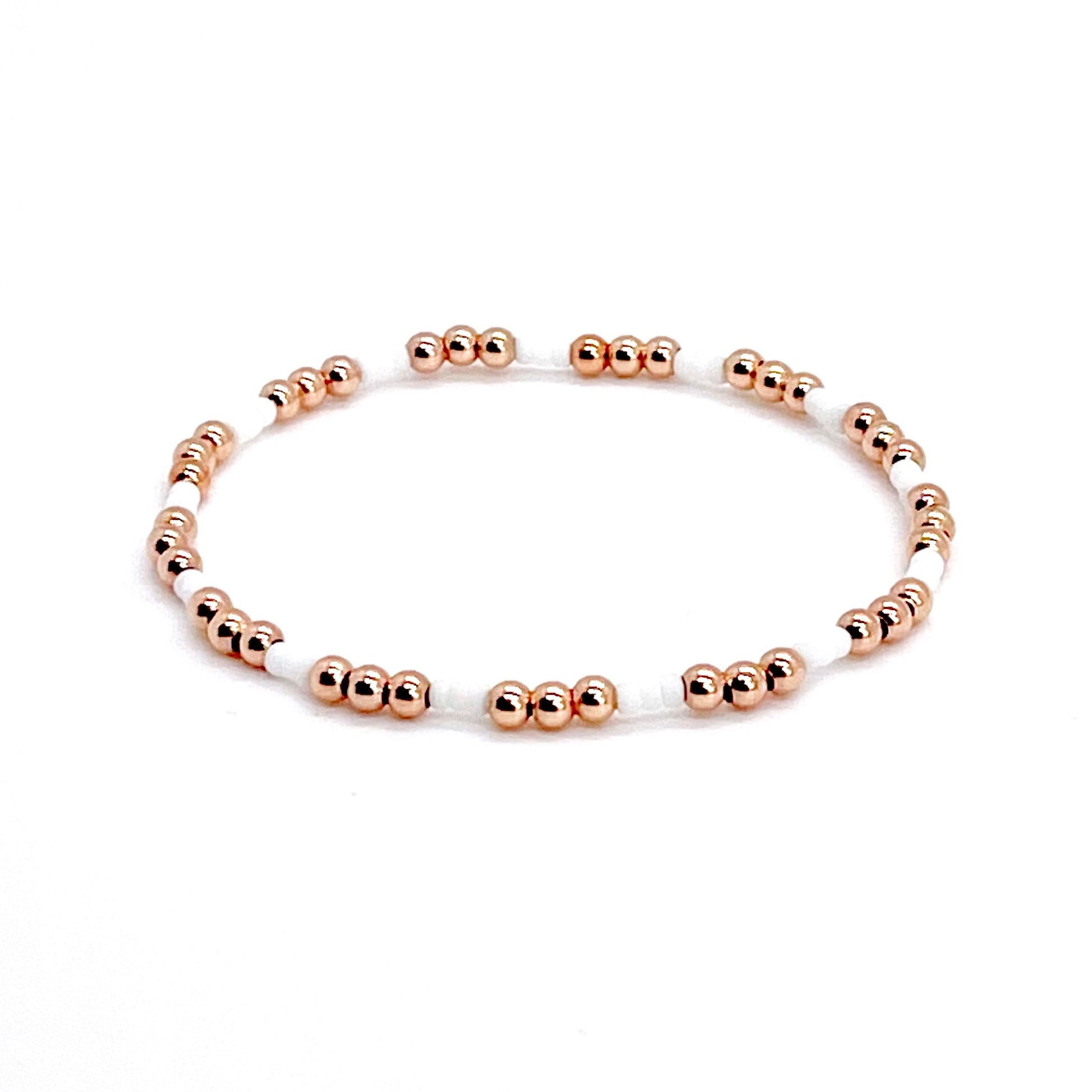 White bead bracelet with 3mm rose gold filled round beads on stretch cord.